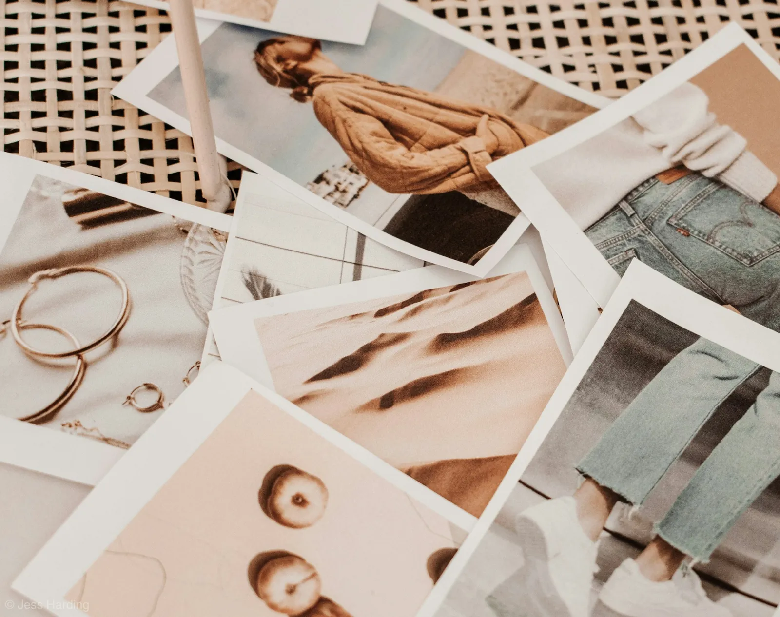 Scattered fashion photo prints of clothing and jewellery in neutral tones
