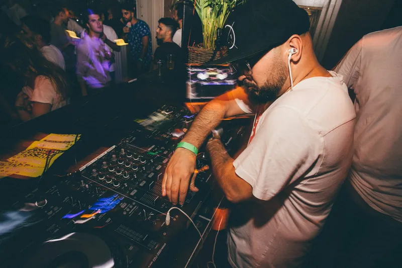 DJ mixing at the decks in a crowded club